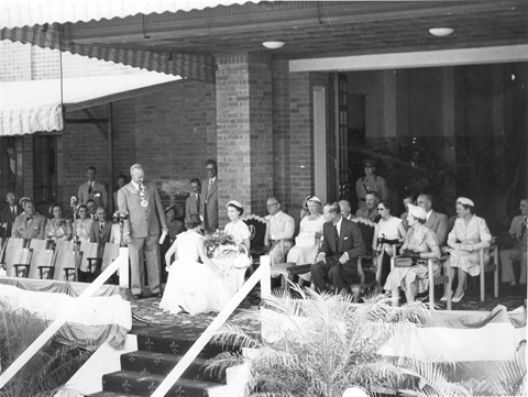 Photograph of Her Majesty Queen Elizabeth receiving a bouquet at the Rockhampton Town Hall 