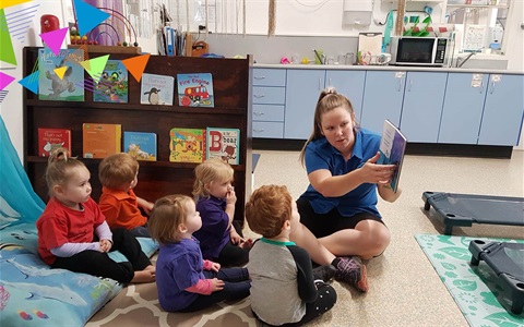 Toddlers reading at City Child Care Centre