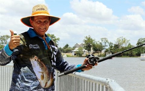 Cr-Williams-throws-a-line-in-the-Fitzroy-River-to-mark-the-start-of-the-2018-Barra-Season.jpg