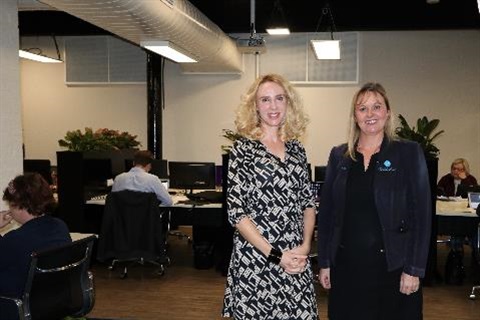 Elize Hattin and Kylie Ufer standing in front of co-working stations at SmartHub