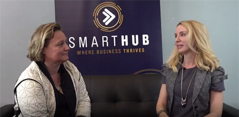 QLD's Chief Entrepreneur Leanne Kemp and Elize Hattin sitting on a couch in front of SmartHub banner