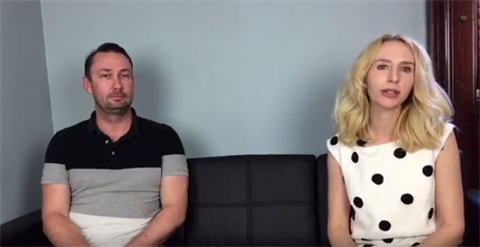 Phil Martin and Elize Hattin sitting on a black couch