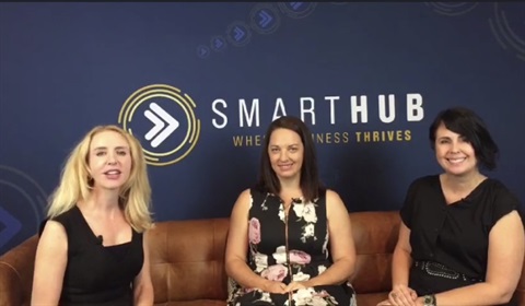 Elize Hattin, Crystal McGregor and Belinda Scott sitting on a tan couch in front of SmartHub logo