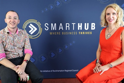 Matt and Elize sitting on stools in front of SmartHub banner