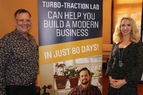 Photo of Monte Huebsch and Elize Hattin standing in front of the Turbo Traction Lab banner