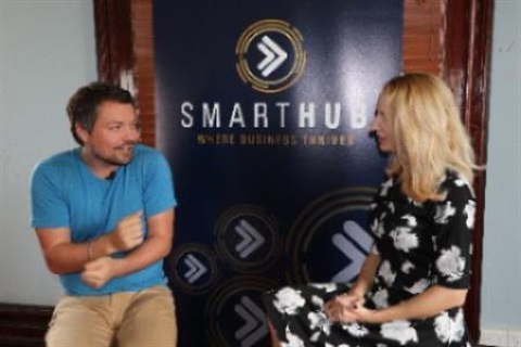 Photo of Daniel Johnsen and Elize Hattin mid conversation in front of the SmartHub Rockhampton banner