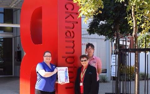 Library staff with prize