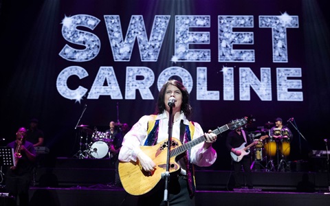 Sweet Caroline Tour singer performing live on stage as Neil Diamond